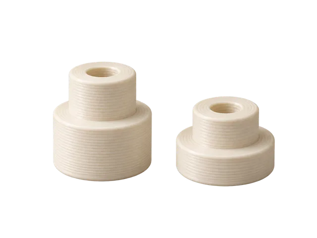 Illustration of two ivory cylindrical spacers with central holes and stepped shoulders
